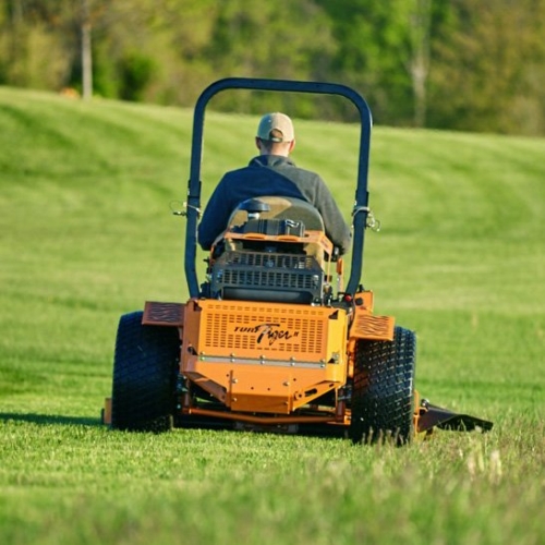 man mowing lawn with scag mower